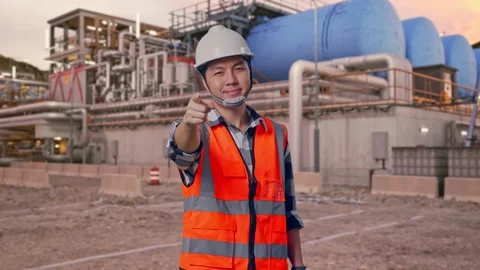 Engineer Smiling And Touching His Chest Then Pointing at Gas Plant Stock Footage 337760275