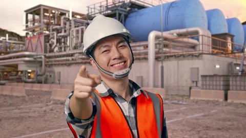 Engineer Smiling And Touching His Chest Then Pointing at Gas Plant Stock Footage 337761153