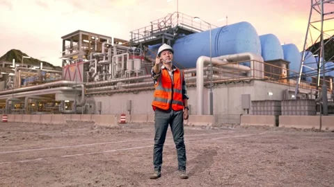 Engineer Smiling And Touching His Chest Then Pointing at Gas Plant Stock Footage 337761819