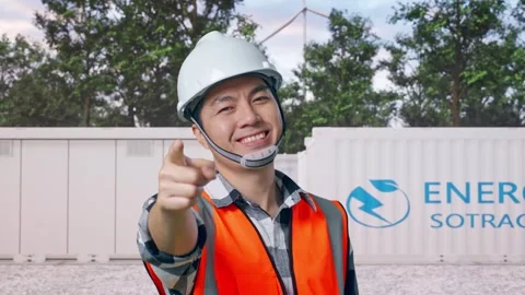 Engineer Smiling And Touching His Chest Then Pointing with Energy Storage Stock Footage 337817100