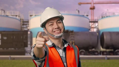 Engineer Smiling And Touching His Chest Then Pointing at Oil Refinery Stock Footage 340140956