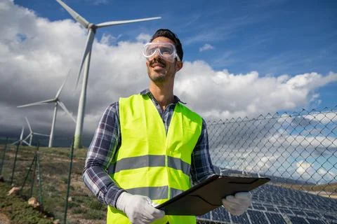 An engineer in a solar power plant at work, confident and smiling successfu.. Stock Photos