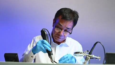 Engineer soldering circuit board in clean tech lab with gloves and tools. I.. Stock Footage 312773828