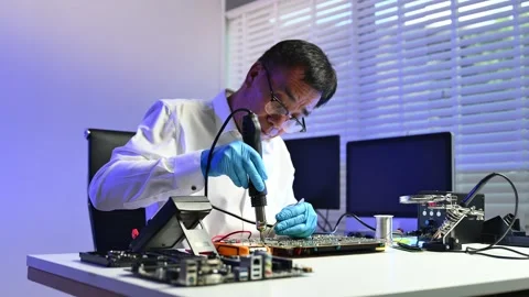 Engineer soldering circuit board in clean tech lab with gloves and tools. I.. Stock Footage 312773887