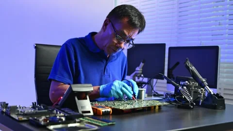 Engineer soldering circuit board in clean tech lab with gloves and tools. I.. Stock Footage 312773975