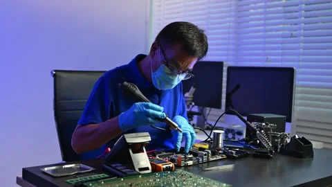Engineer soldering circuit board in clean tech lab with gloves and tools. I.. Stock Footage 312774033