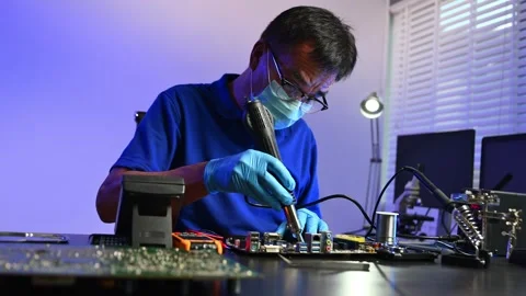 Engineer soldering circuit board in clean tech lab with gloves and tools. I.. Stock Footage 312774036