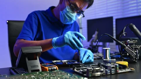 Engineer soldering circuit board in clean tech lab with gloves and tools. I.. Stock Footage 312774072