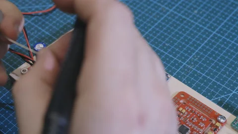 Engineer solders audio player board with soldering iron Stock Footage 194522920