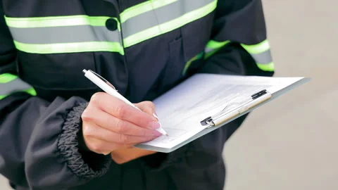 The engineer in a special form makes a note in a notebook. A woman marks the Stock Footage 258472984