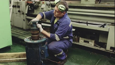 Engineer in special gloves repairs electric motor on tanker Stock Footage 130995158