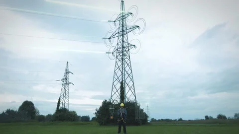 Engineer standing beside the electromagnetic towers with computerized Video stock 141489168