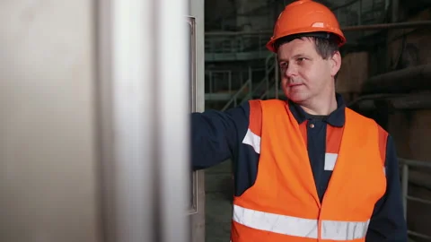 Engineer standing in front of industrial machine and going to press one buttons Stock-Footage 147056828