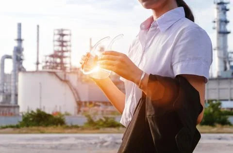The engineer is standing on large industry background. Stock Photos