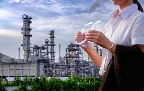 The engineer is standing on large industry background. Stock Photos