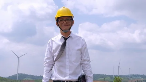 Engineer standing smile happily at windmill power plant. Stock Footage 116555418