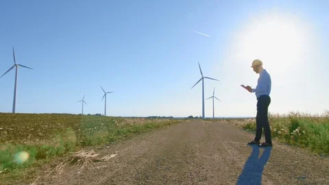 The engineer stands on the background of the windmills. Stock-Footage 76587767
