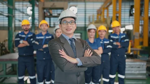 Engineer stands confident with arms crossed in factory Stock Footage 341925042