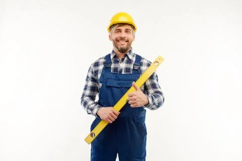 Engineer stands with a leveling ruler in his hands on a white background Stock Photos