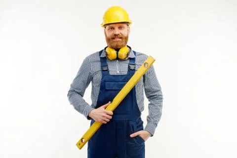 Engineer stands with a leveling ruler in his hands on a white background Stock Photos