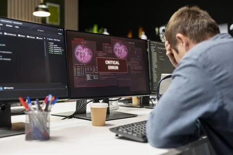 Engineer in startup office does facepalm, worried after struggling to fix errors 스톡 사진