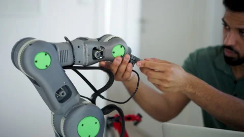 Engineer struggling with a technical problem while building robotic arm. Stock Footage 310209603