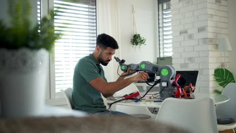 Engineer struggling with a technical problem while building robotic arm. Stock Footage 310209627