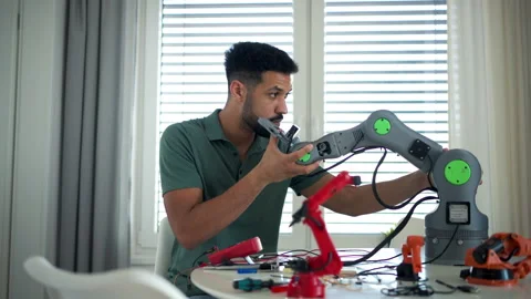 Engineer struggling with a technical problem while building robotic arm. Stock Footage 310209634