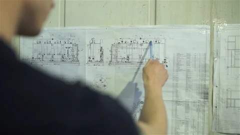 The engineer studies the scheme of membrane bio-reactor Stock Footage 92332782