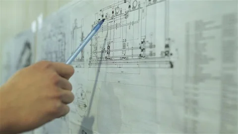The engineer studies the scheme of the water treatment plant Stock Footage 92332764