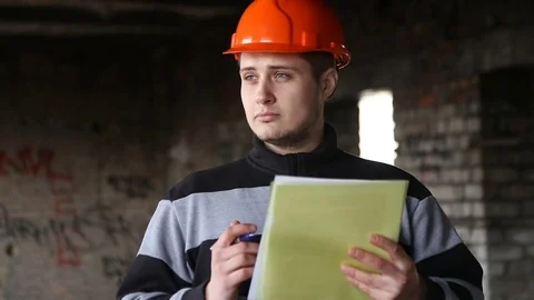 The engineer studies the working documents in the production. Stock-Footage 73453925