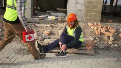 Engineer suffered injury at work calls colleague with first aid kit for help Stock Footage 275073946