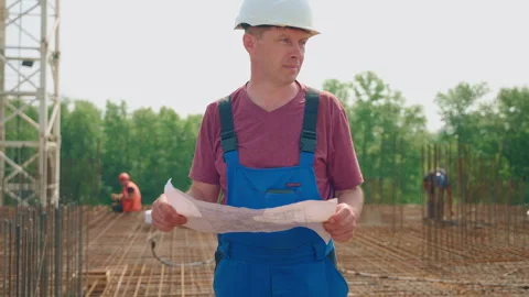An engineer supervises the construction process of a residential complex Stock Footage 263962663