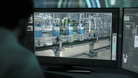 An Engineer supervises the conveyors using the program at the dairy facility Stock Footage 289258949