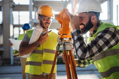 Engineer surveyor working with theodolite at construction site Stock Photos