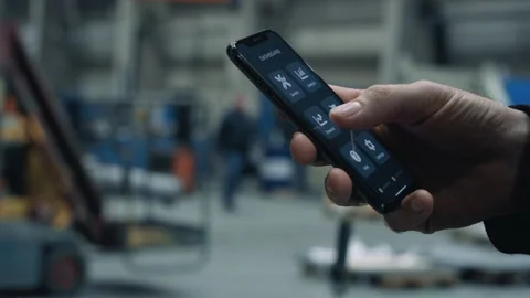 Engineer swiping through forecast analysis app on smartphone Stock Footage 132705140