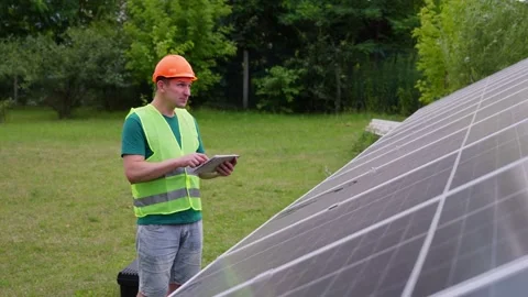 Engineer with tablet analyze efficiency of renewable green energy Stock Footage 316232353