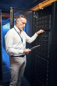 Engineer, tablet and rack inspection in server room for system health, powe.. Stock Photos