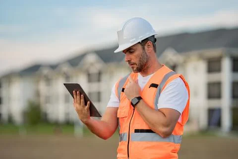 Engineer with tablet, building inspection. Builder at building site 스톡 사진