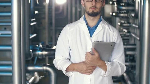 Engineer with tablet PC at the factory Stock Footage 77778034