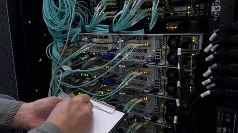 The engineer with the tablet in the server room. Check of the server hardware. Stock Footage 98487223