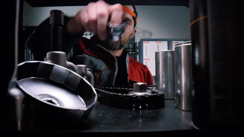 Engineer takes a car repair tool from a shelf. A wide-angle macro shot Stock Footage 340580868