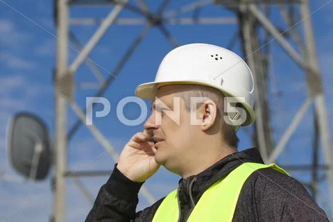 Engineer talking on the cell phone near to gsm tower Stock Photos