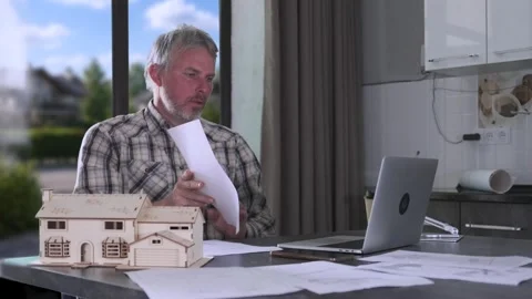Engineer talking during video call, reviewing documents and working from home Stock Footage 334870953