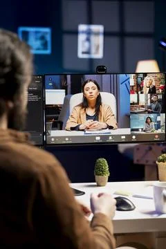 Engineer talking with management in videocall about errors found in code Stock Photos