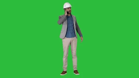 Engineer talking a mobile phone inspecting construction work of crane on a Green Stock Footage 111067521