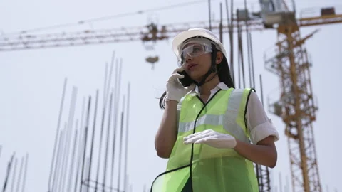 Engineer talking on a mobile phone standing of under development building. Video stock 162017198