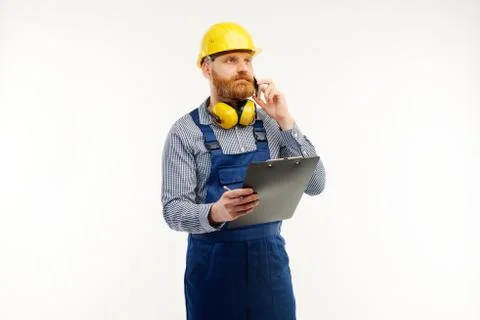 Engineer talking on the phone with a notepad in his hand on a white background Stock Photos