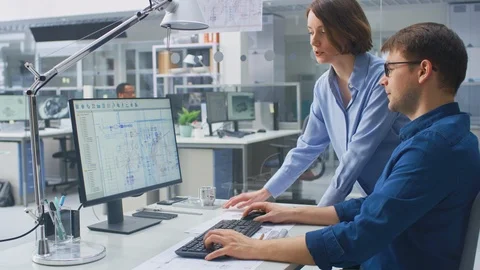 Engineer Talking With Project Manager and Working on Desktop Computer Using CAD Video stock 107773642