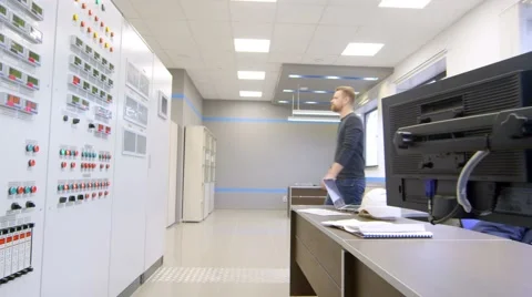 Engineer talking on a walkie-talkie and presses the button on the panel inside Stock Footage 61355083